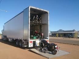 alt= "Image of motocycle trailer hauling motorcycles"